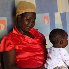 Eglyne Indeku with his son Ezekiel Mwenje during a home visit