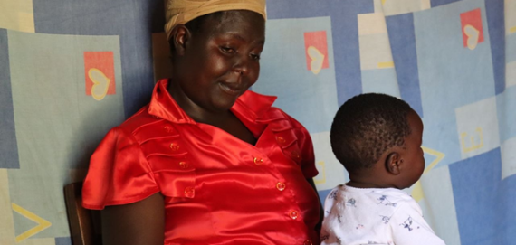 Eglyne Indeku with his son Ezekiel Mwenje during a home visit